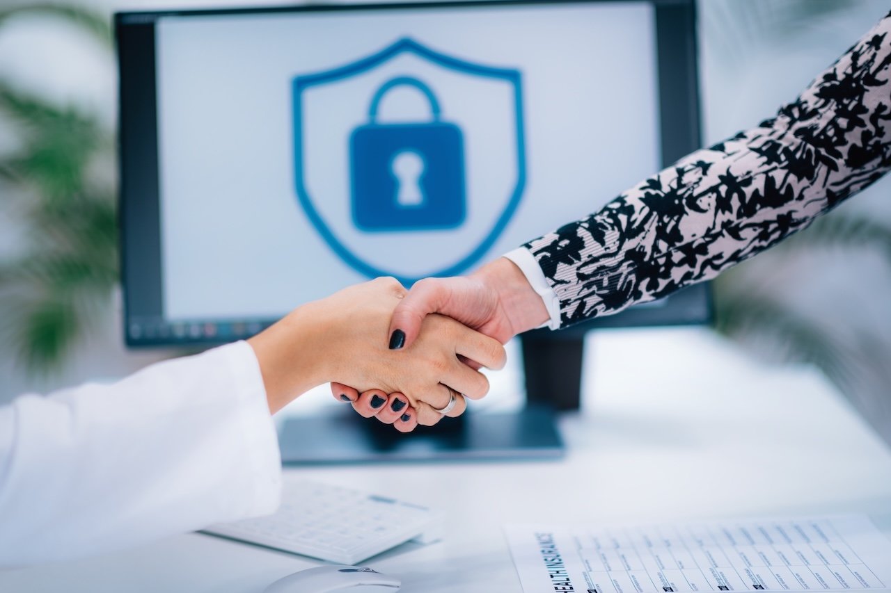cyber insurance agent shaking hands with business owner